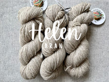 Load image into Gallery viewer, Three skeins of yarn labeled 'Helen Aran' on a gray background with Heavenly Yarns branding.