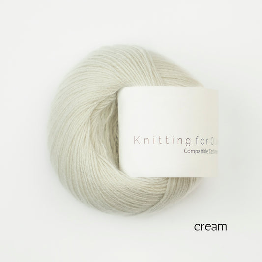 Cream-colored yarn skein with 'Knitting for Olive' label on a white background