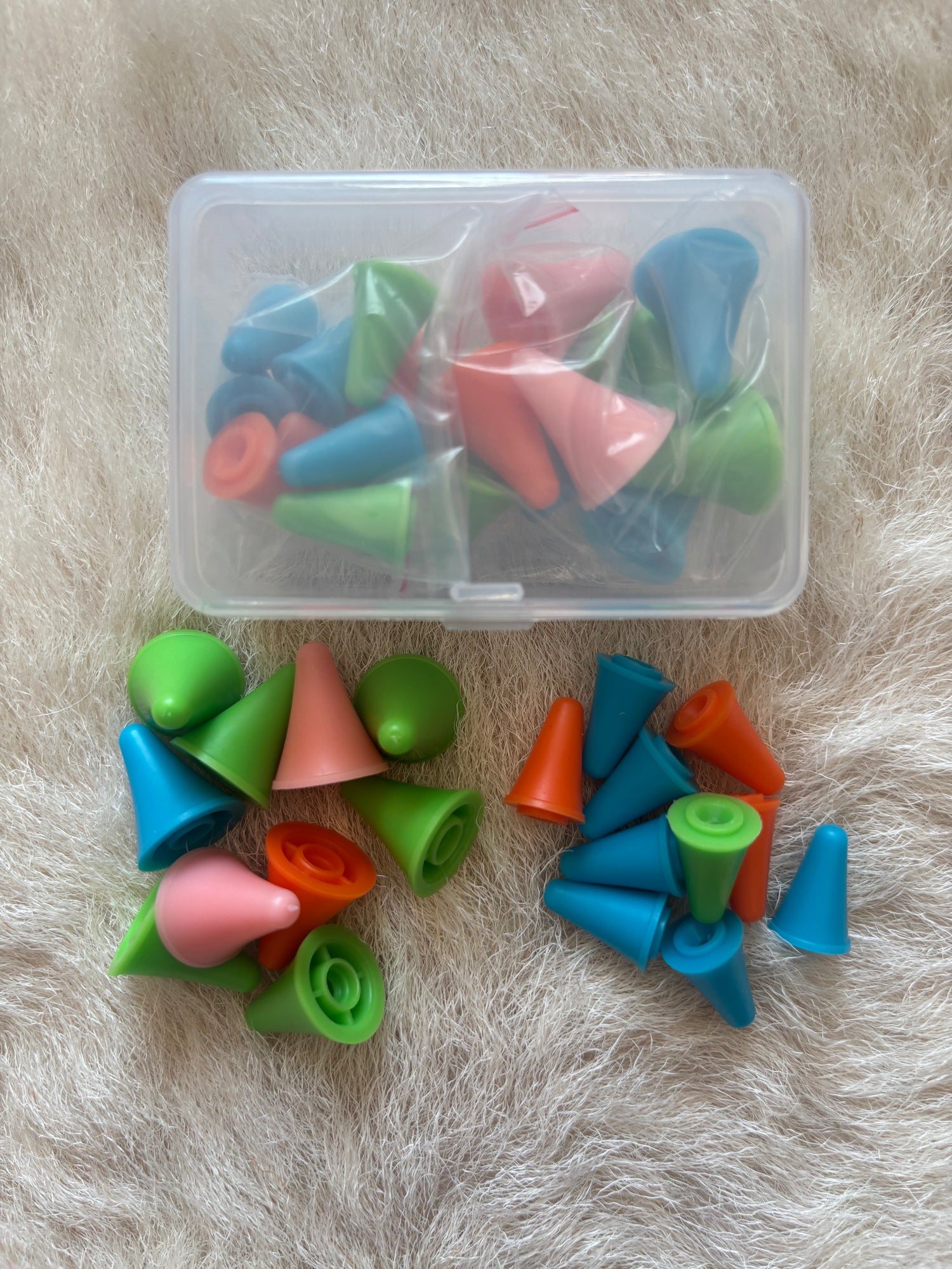 A set of colorful plastic knitting needle point protectors