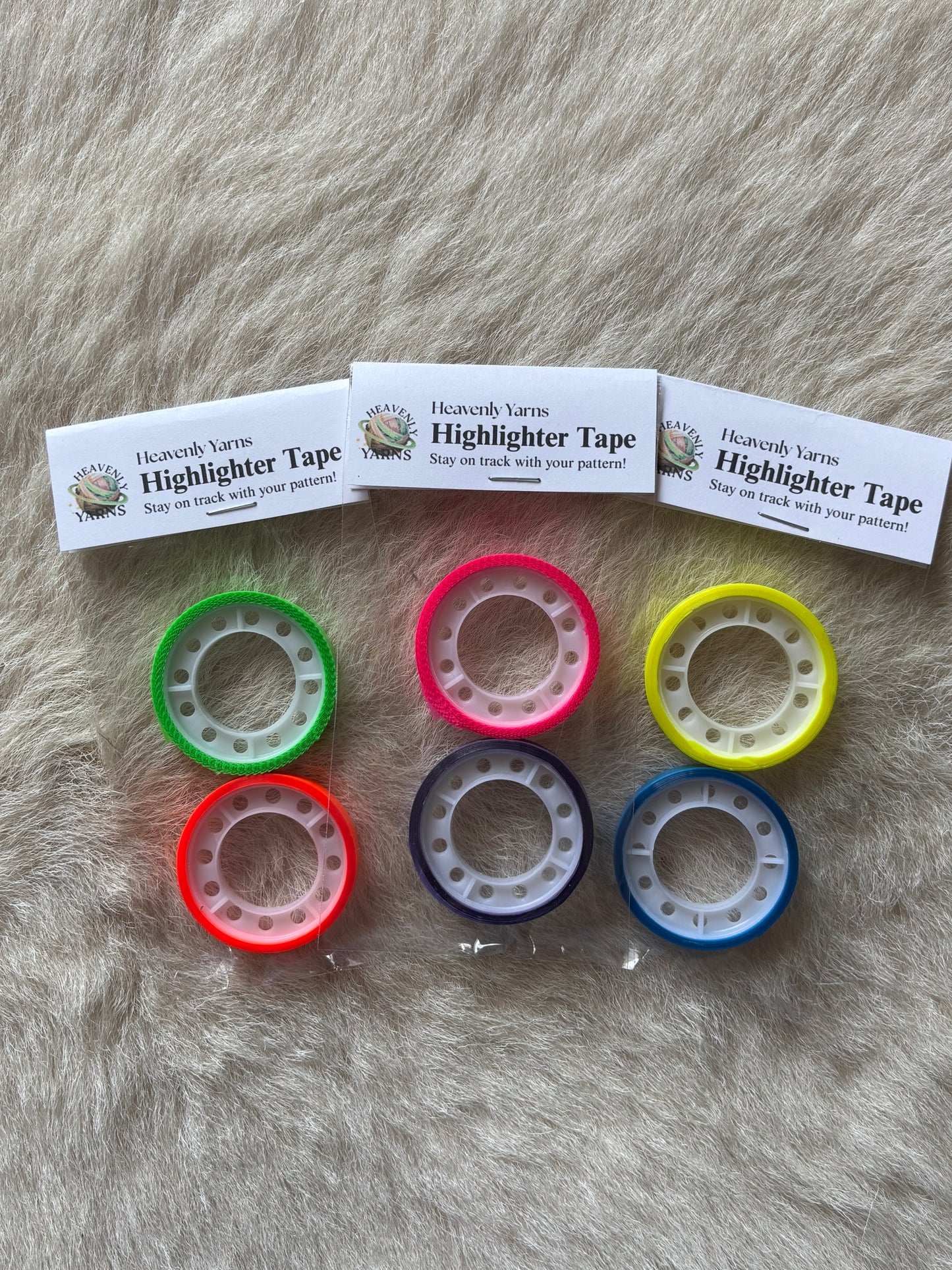 Six rolls of colorful highlighter tape in green, pink, yellow, red, purple, and blue. The labels read 'Heavenly Yarns Highlighter Tape'.