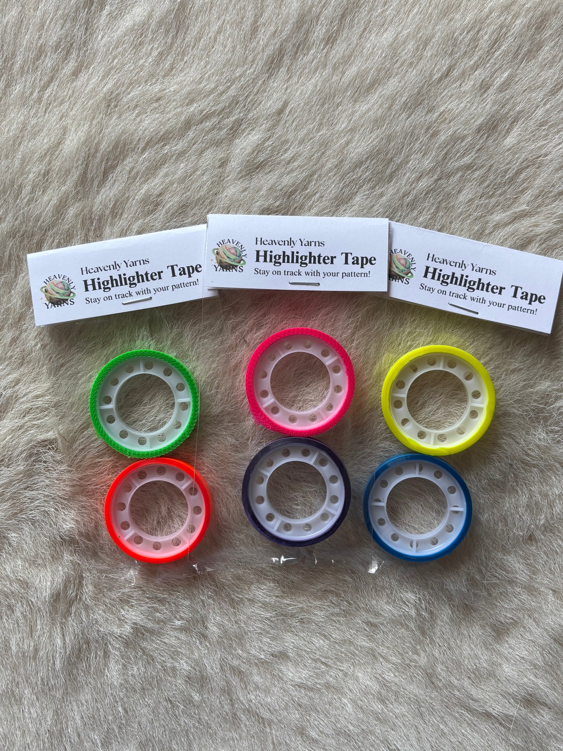 Six rolls of colorful highlighter tape in green, pink, yellow, red, purple, and blue. The labels read 'Heavenly Yarns Highlighter Tape'.