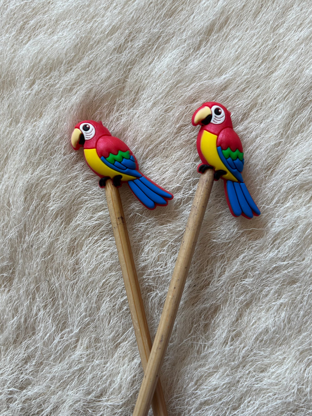 Parrot knitting needle point protectors. 