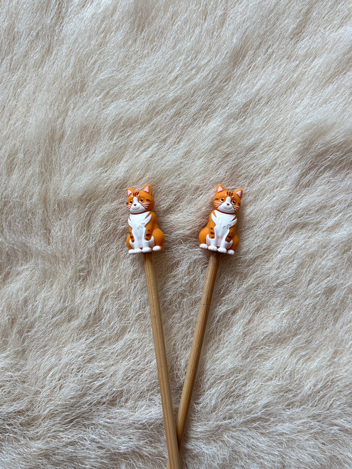 Orange Cat knitting needle point protectors.