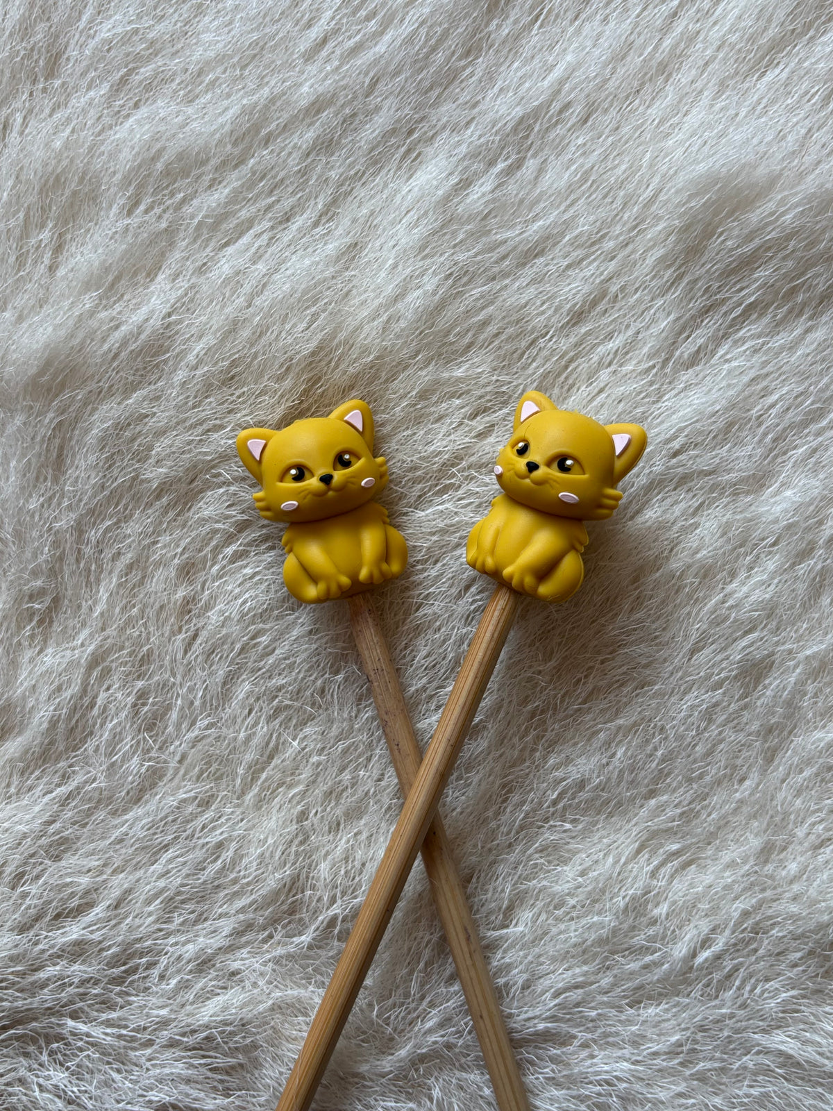 Yellow Cat knitting needle point protectors.