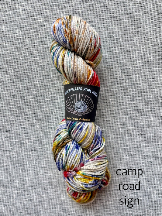 Freshwater Purl Fiber merino yarn in camp road sign