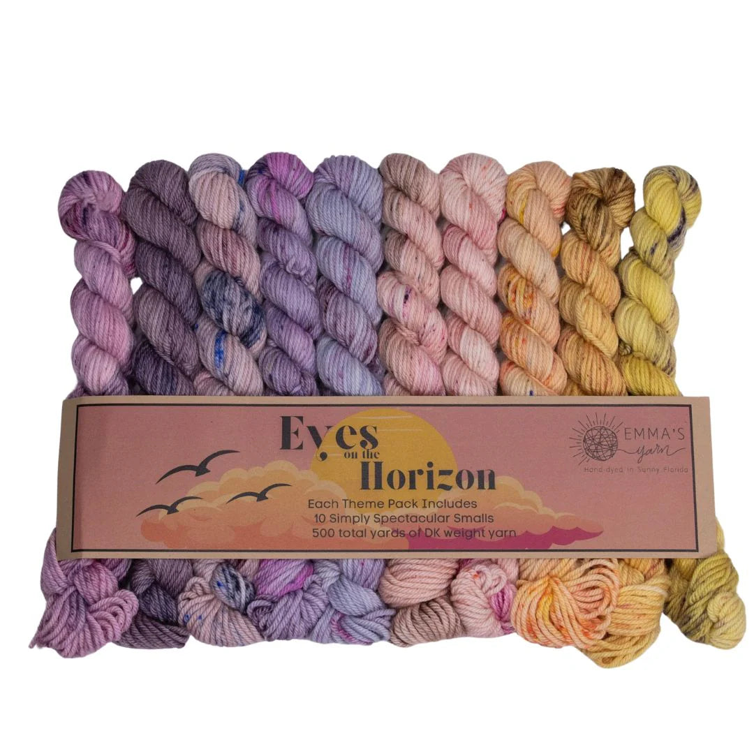 Emma's Yarns 'Eyes on the Horizon' 10-skein dk yarn bundle, featuring 10 different colored variegated yarns in shades of purple, pink, orange, and yellow.